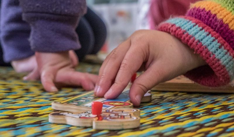 Child playing on the mat